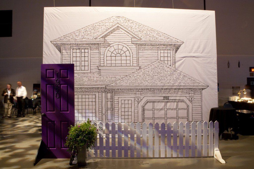 A drawing of a house with a purple door and a white picket fence