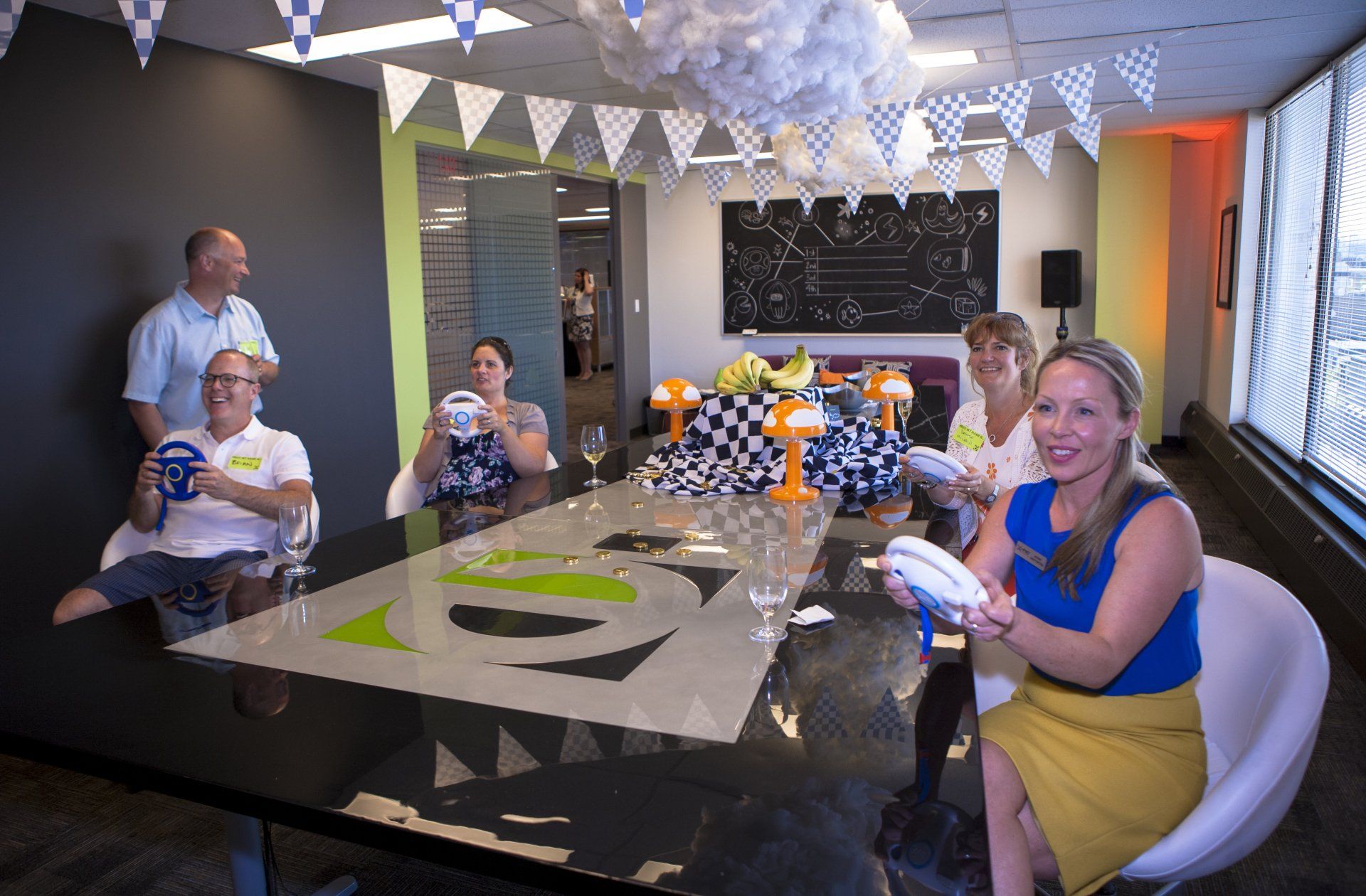 A group of people are sitting around a table in a room.