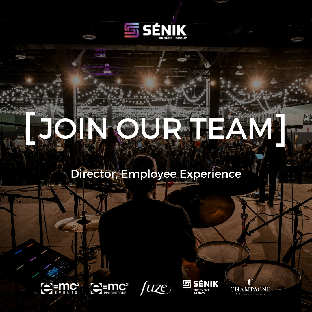 A man is playing drums on a stage in front of a crowd.