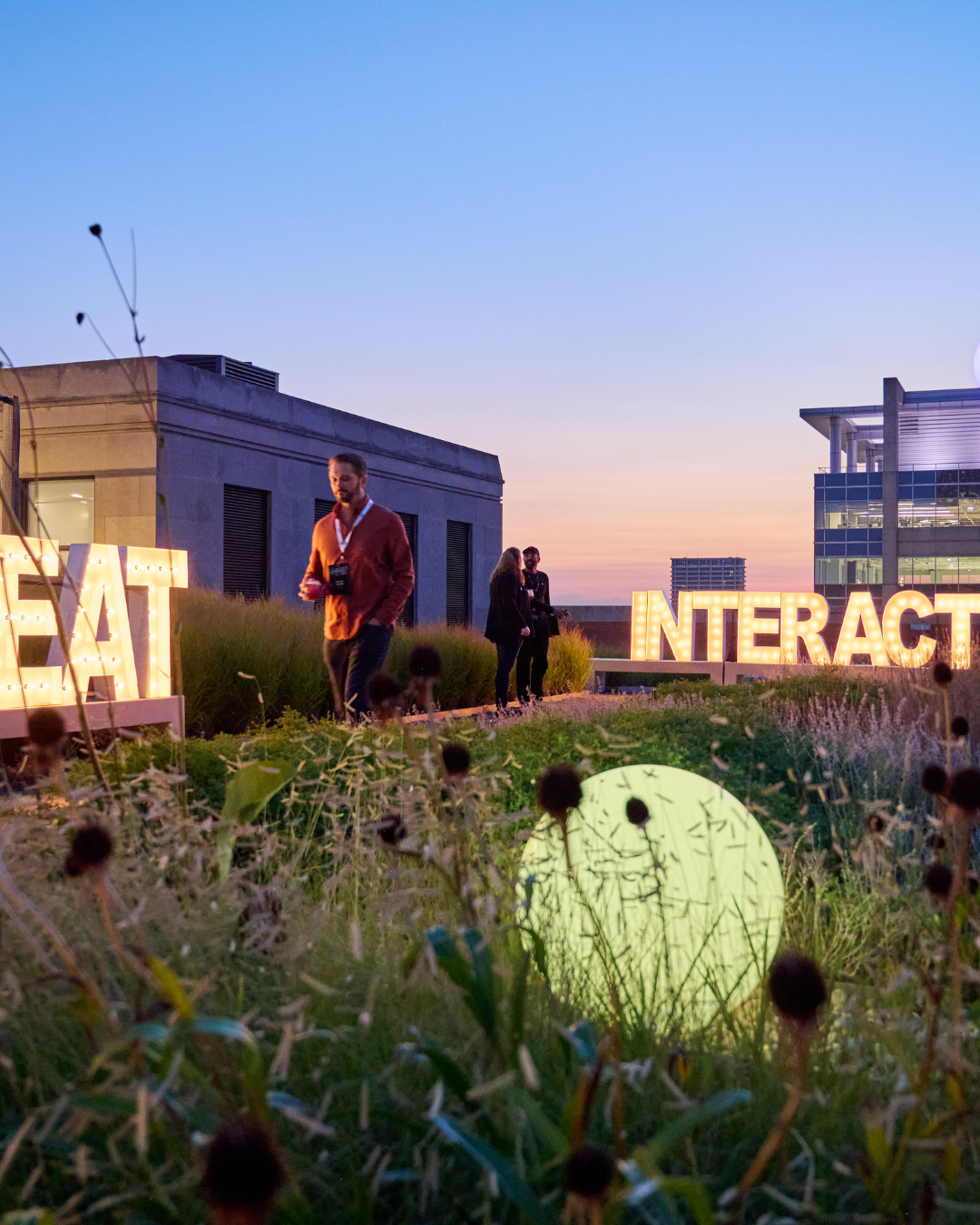 A rooftop garden with illuminated signs 