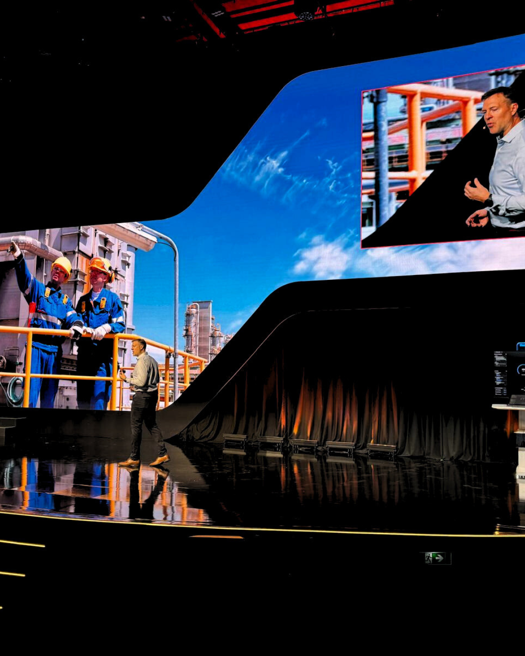 A large screen with a picture of a man on it