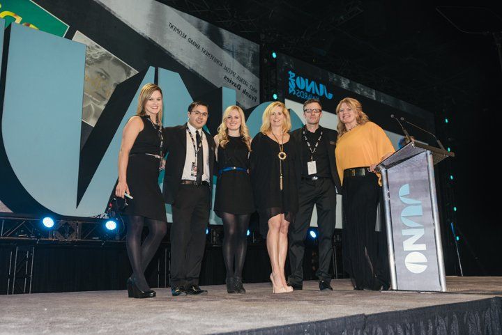 A group of people standing in front of a podium that says onap