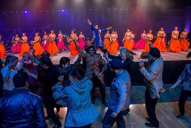 A group of people are dancing on a stage.