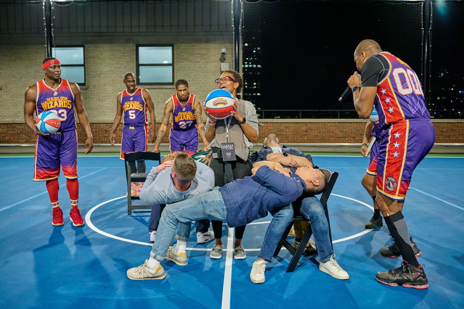 A group of men are playing basketball on a court.