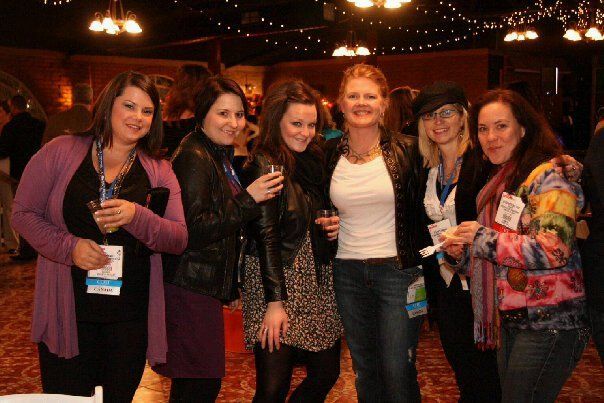 A group of women posing for a picture in a room
