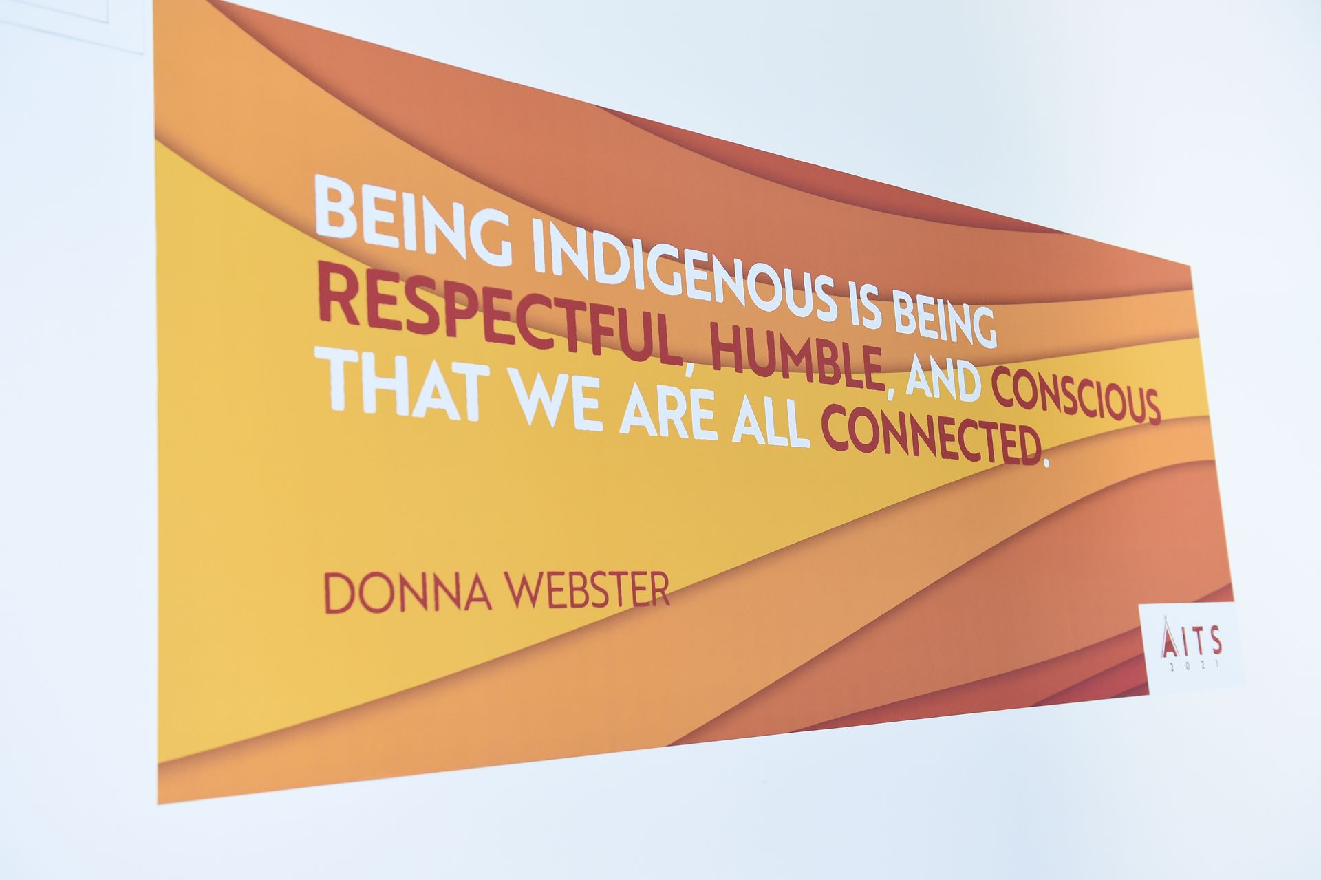 A poster on a wall that says `` being indigenous is being respectful humble and conscious that we are all connected ''
