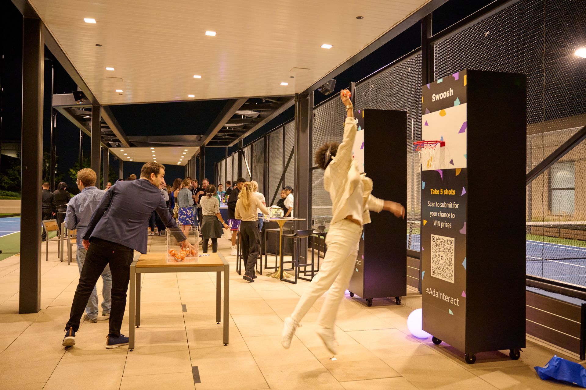 A group of people are standing around a table in a room.