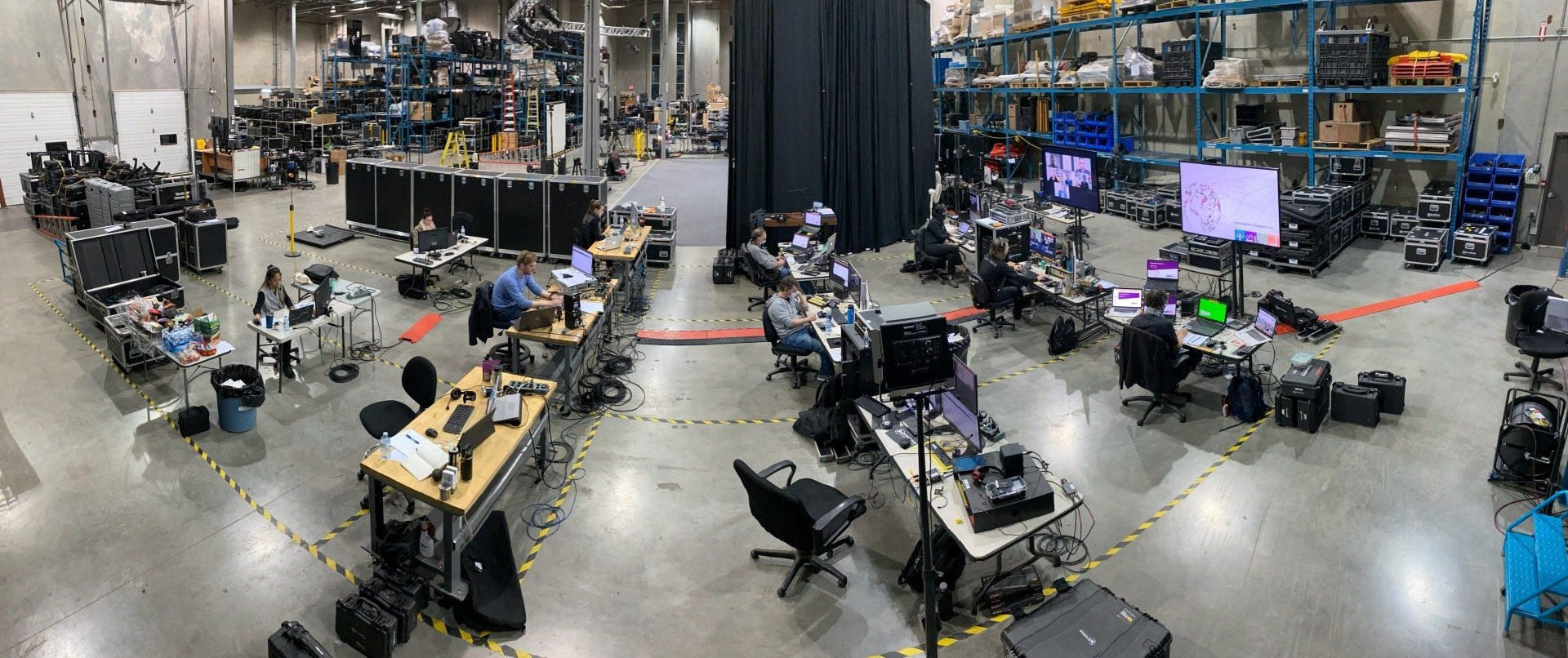 A large warehouse filled with lots of tables and chairs.