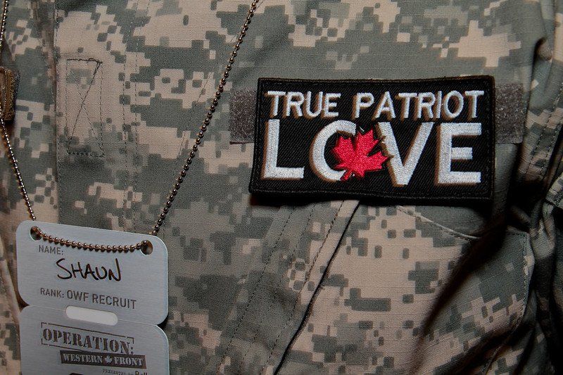 A patch that says true patriot love on a military uniform