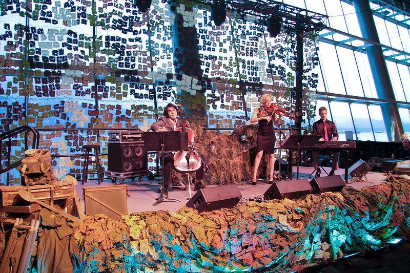 A group of people are playing instruments on a stage.