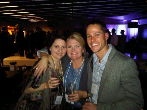 Three people posing for a picture in a dark room