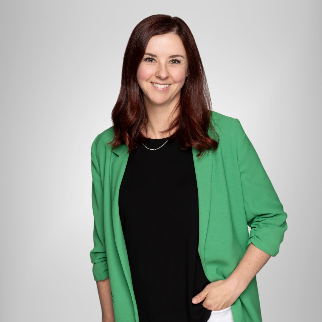 A woman wearing a green jacket and a black shirt