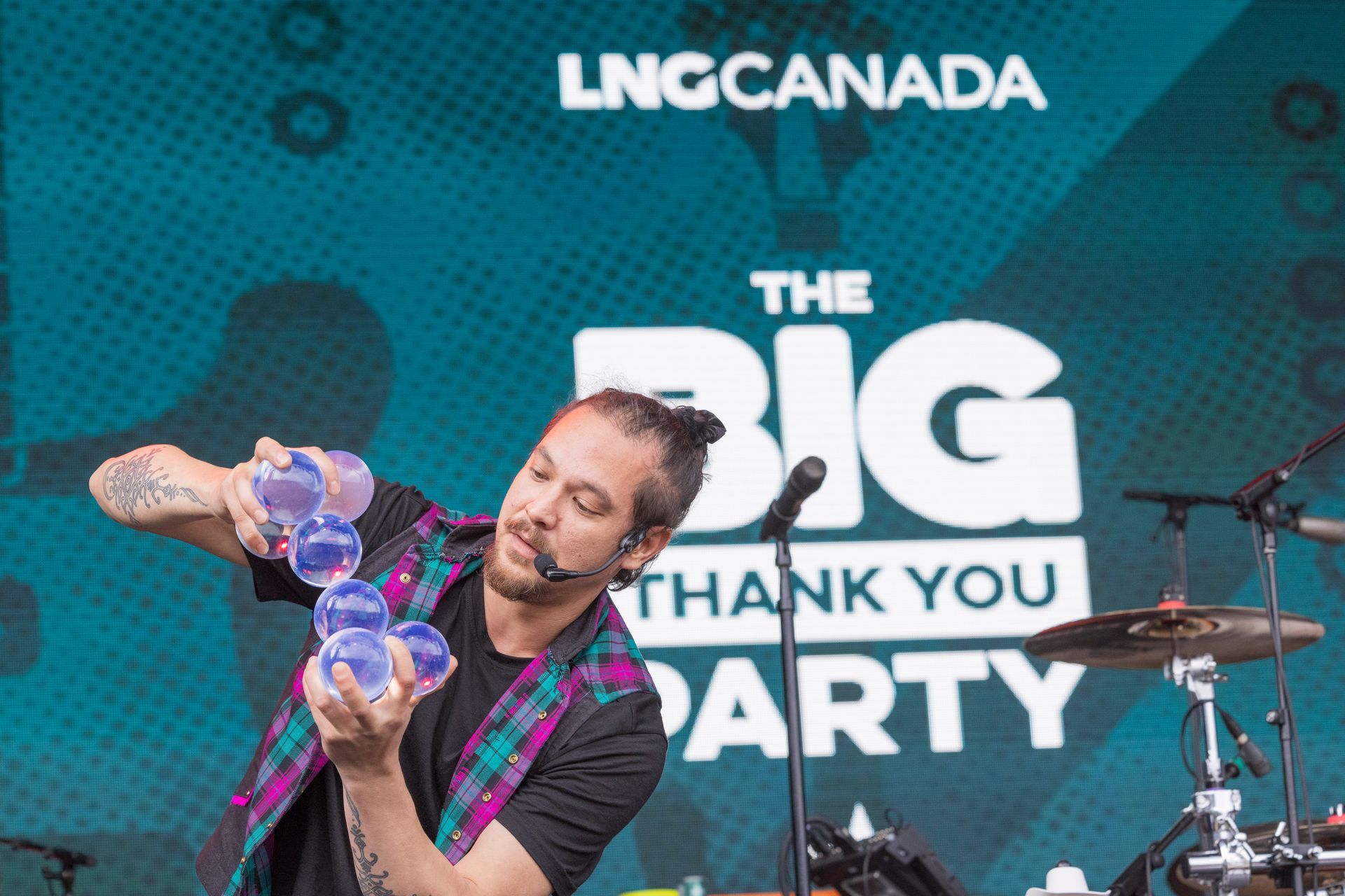 Man pours liquid through clear cups at 