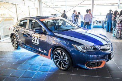 A blue car with the number 87 on the side is parked in a showroom.