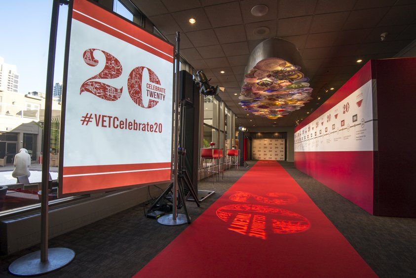A hallway with a red carpet and a sign that says 20