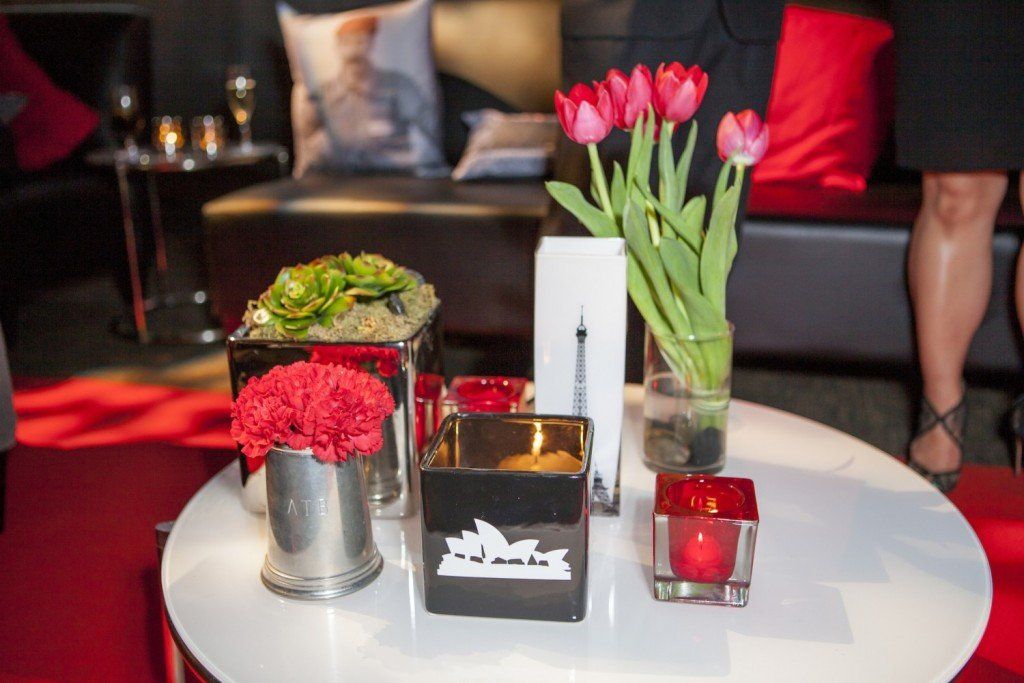 A table with a vase of flowers and candles on it