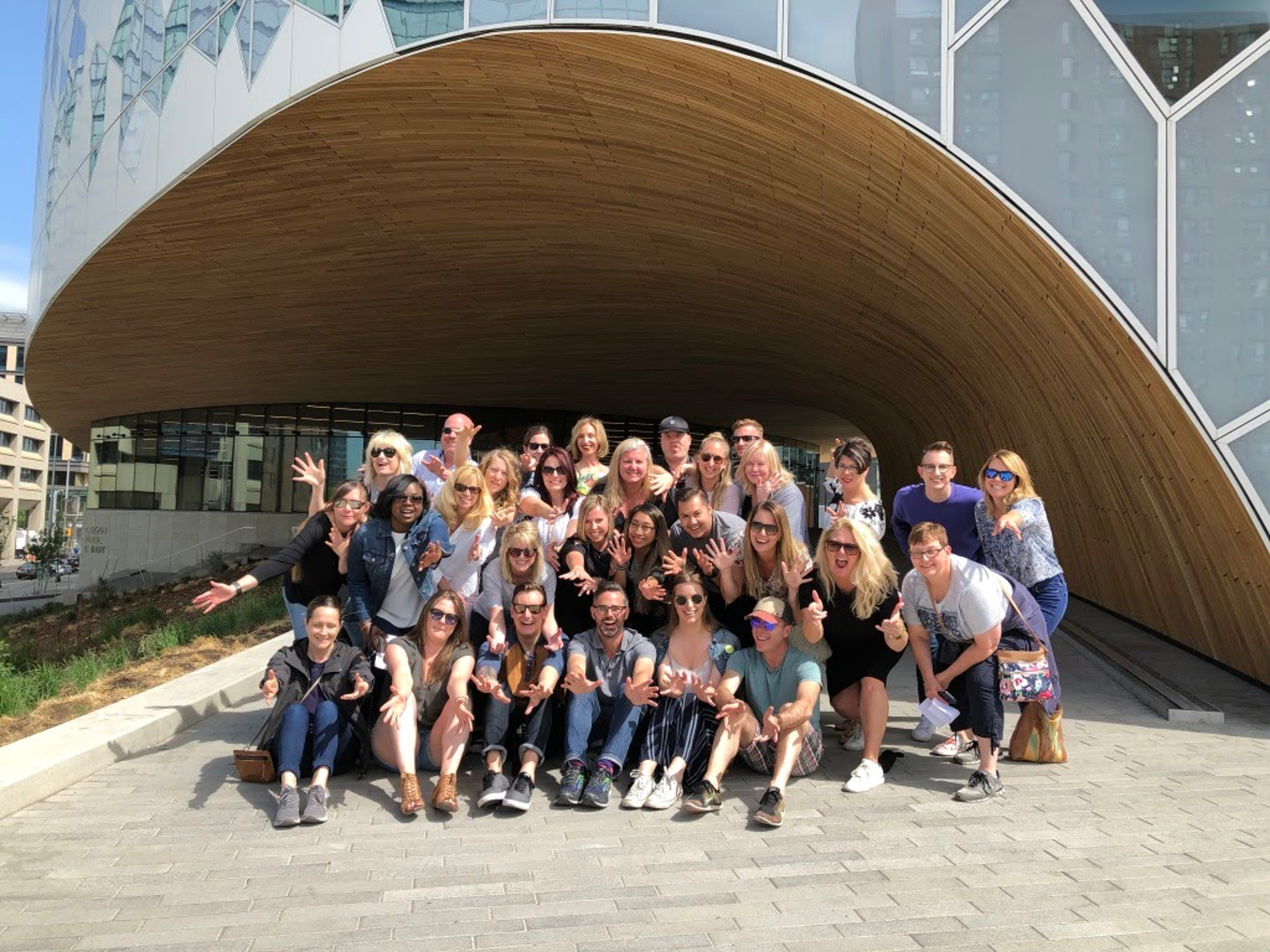 A group of people are posing for a picture in front of a building.