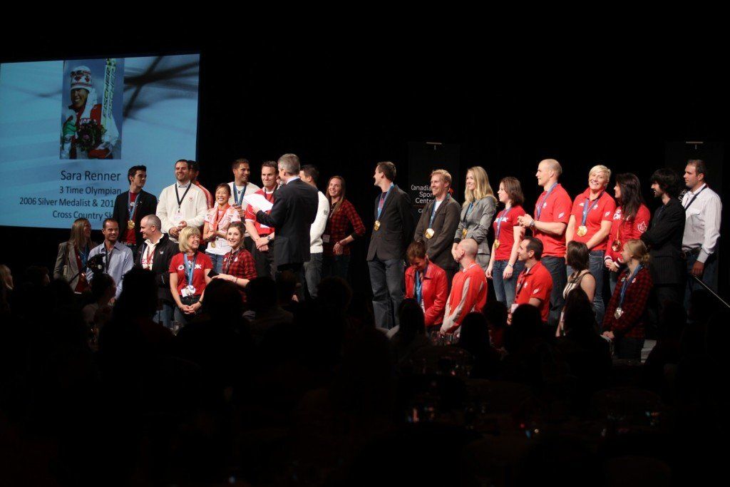 A group of people are posing for a picture on a stage