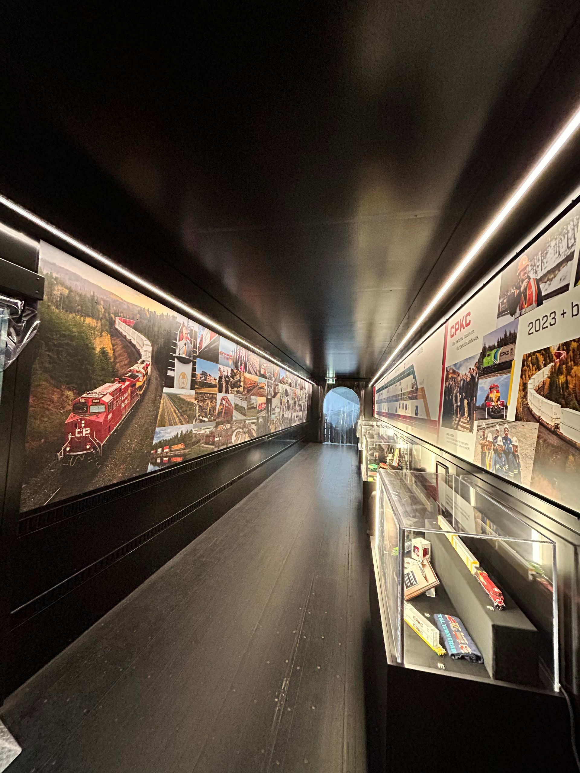 A long hallway with a lot of pictures on the wall.