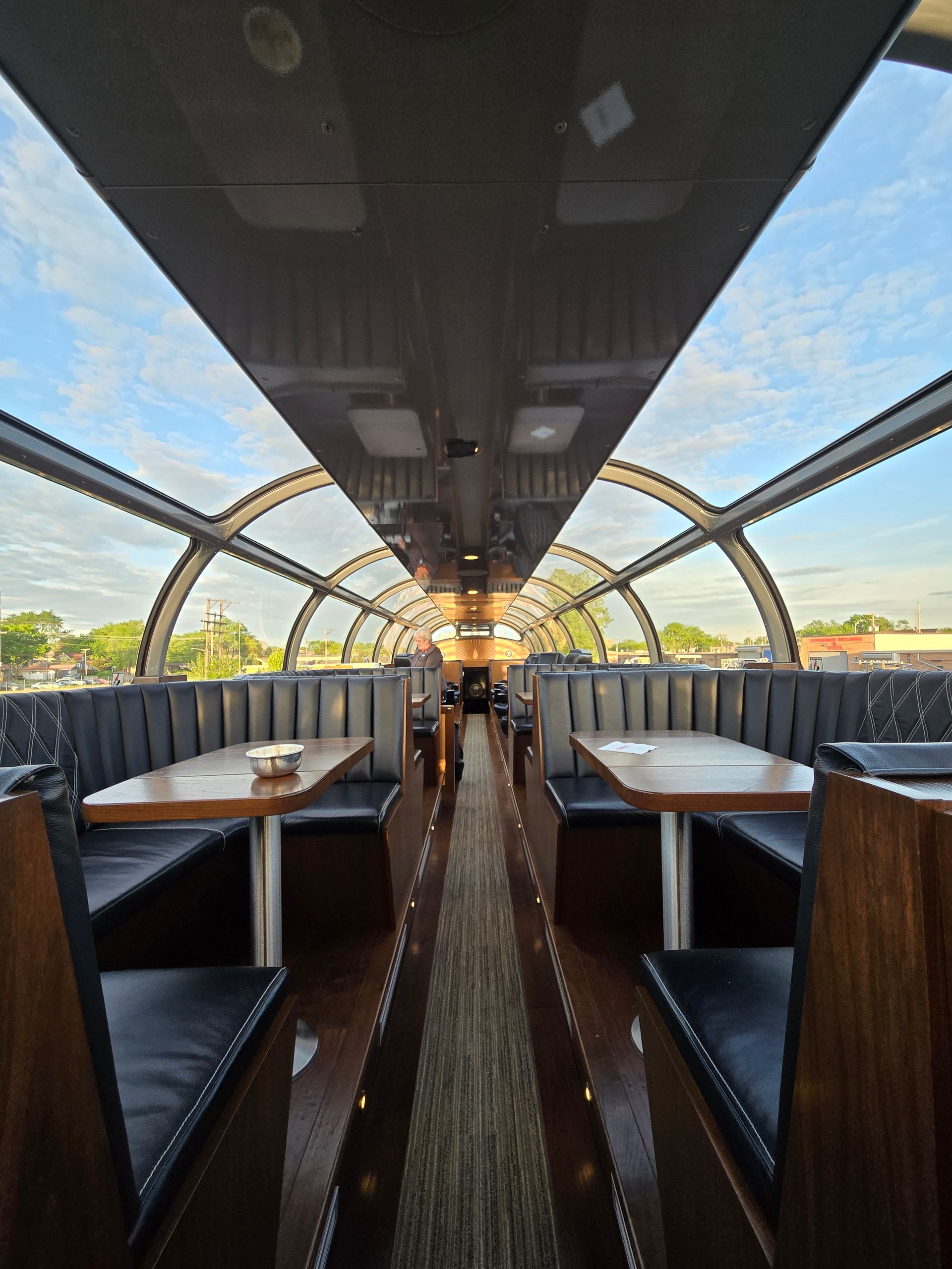 The inside of a restaurant with tables and benches