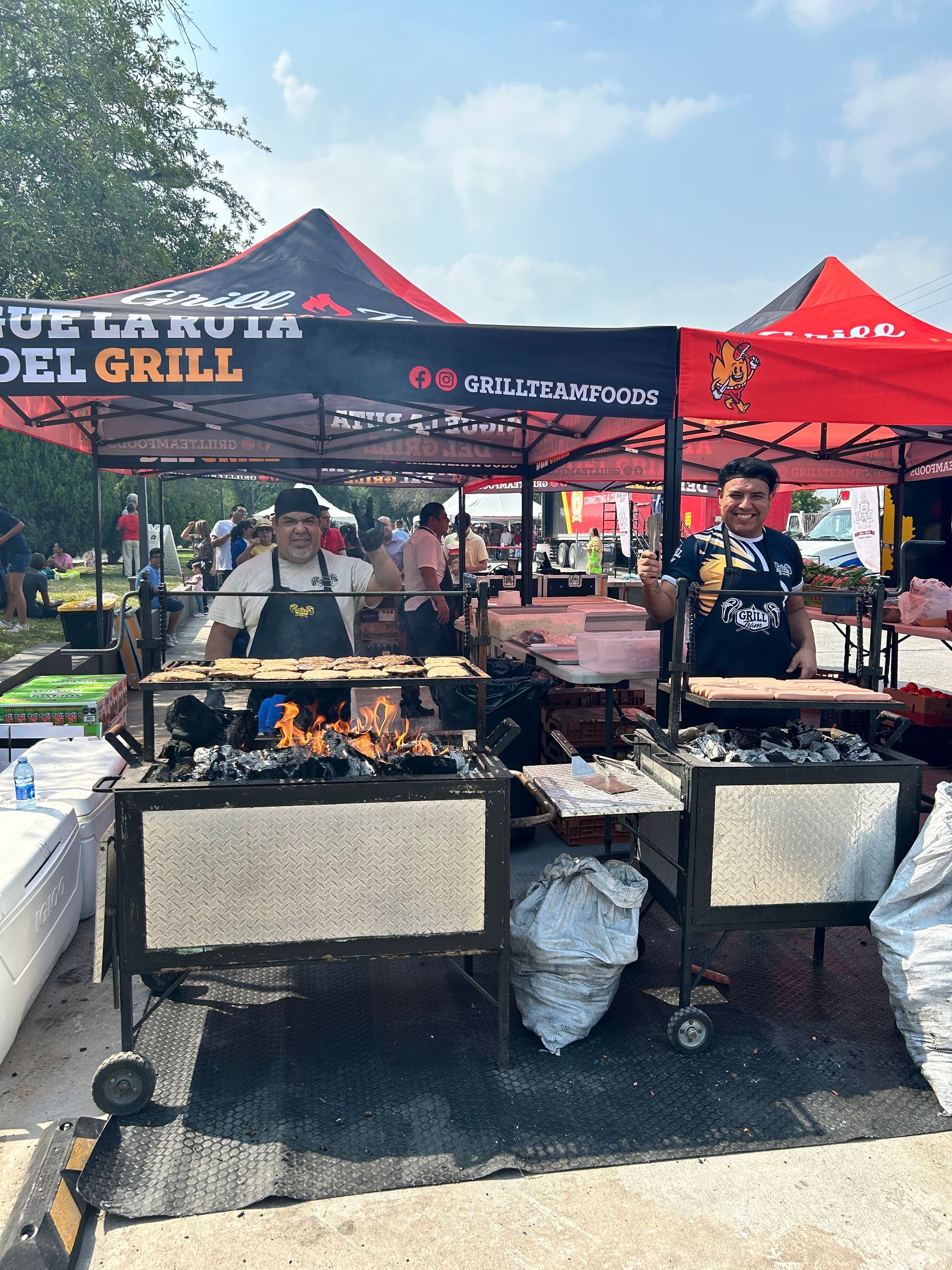 A man is standing in front of a grill with a sign that says del grill