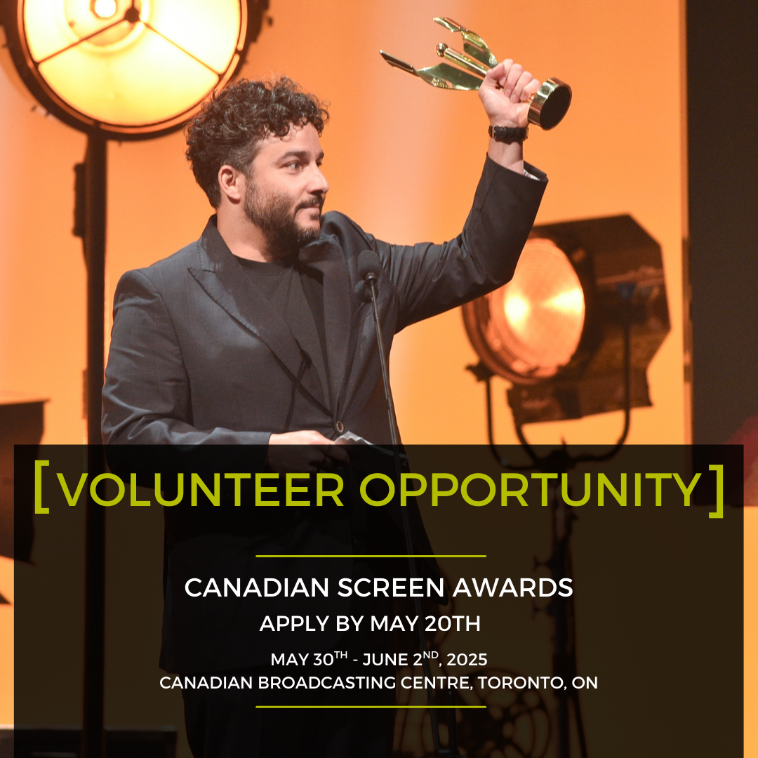 A man in a suit is holding a trophy in front of a microphone ..