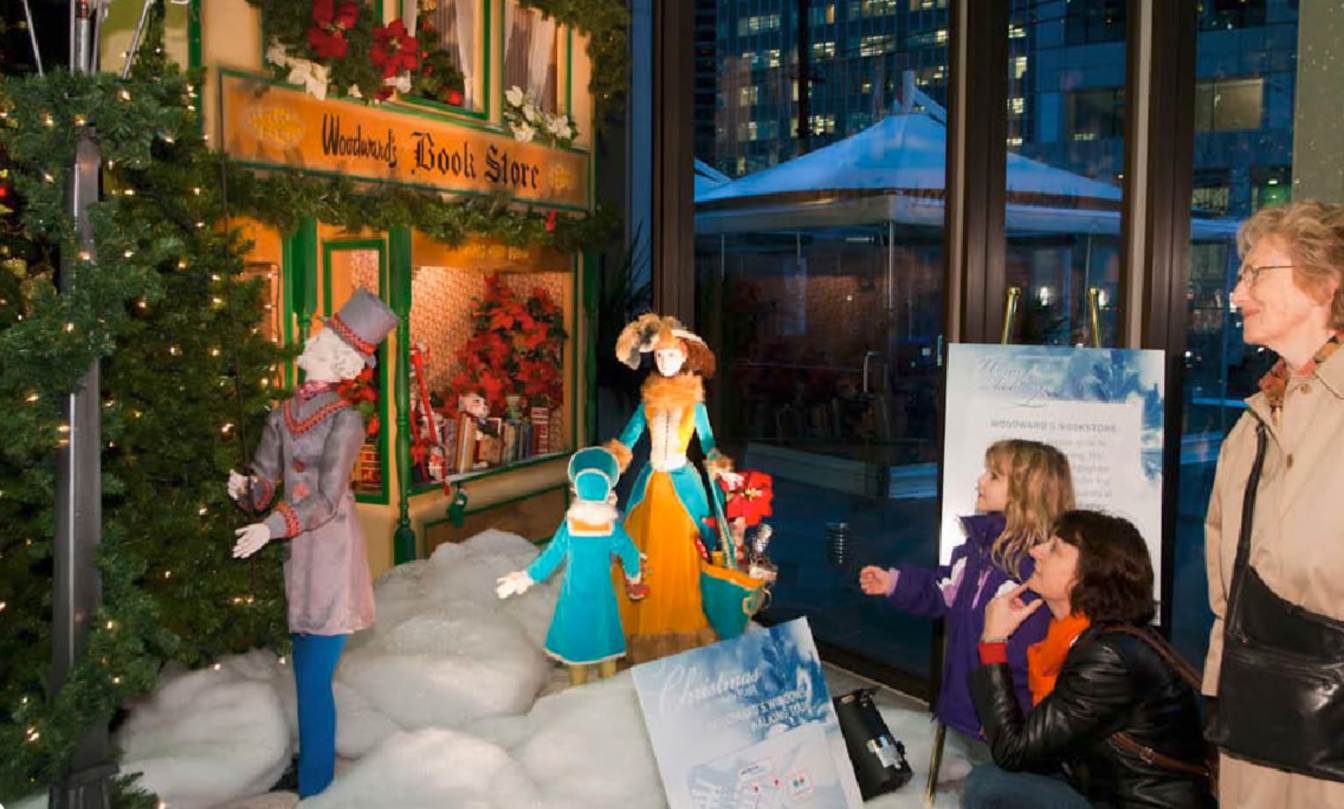 A woman and a child are looking at a christmas display.