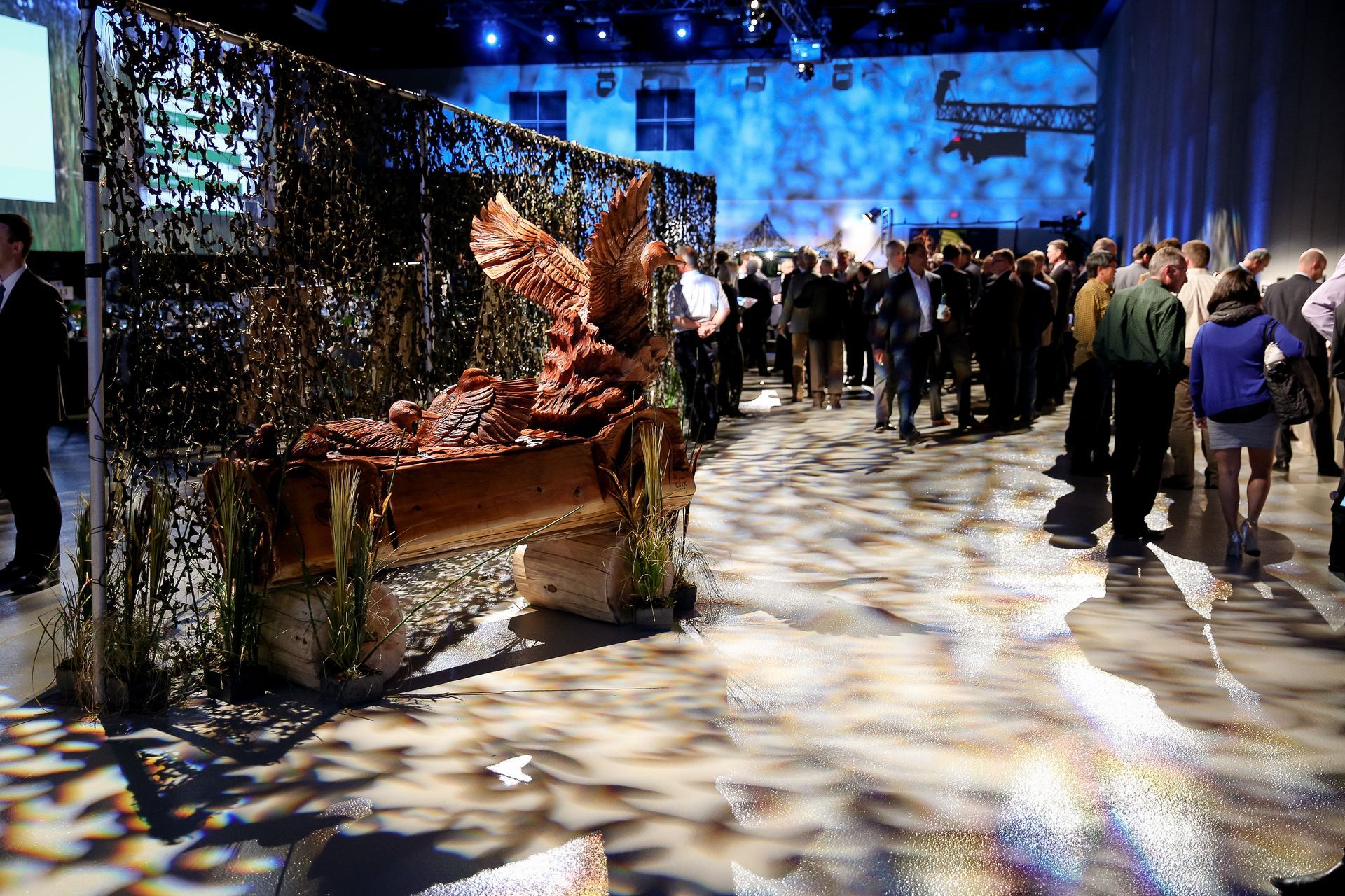 A crowd of people are gathered in a large room