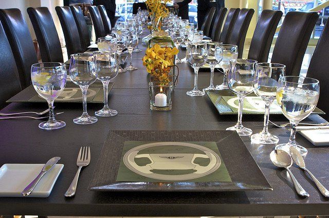 A long table with plates and glasses on it