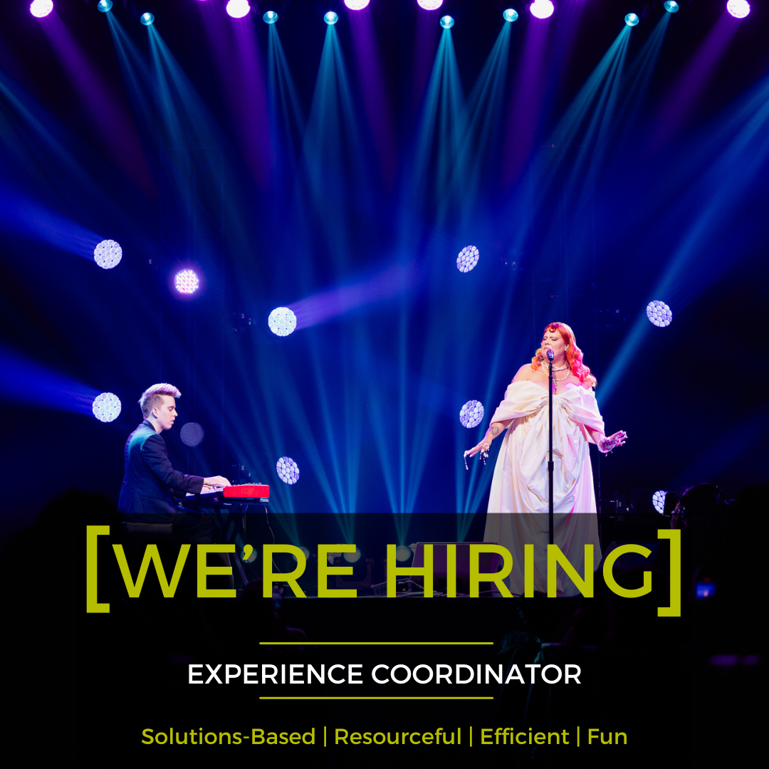 A man is playing a keyboard and a woman is singing into a microphone on a stage.