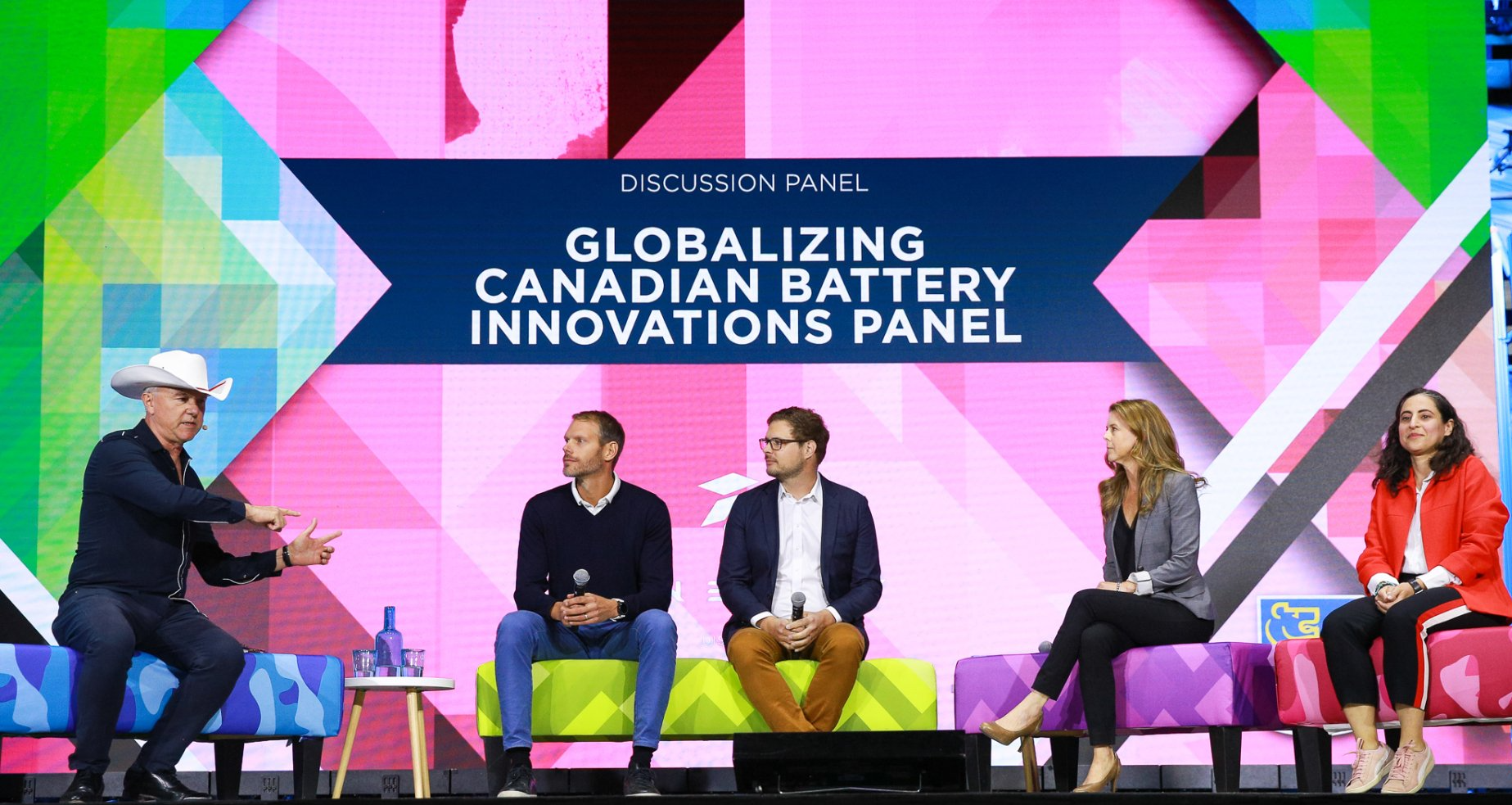 A group of people are sitting on a stage in front of a sign that says globalizing canadian battery innovations panel.