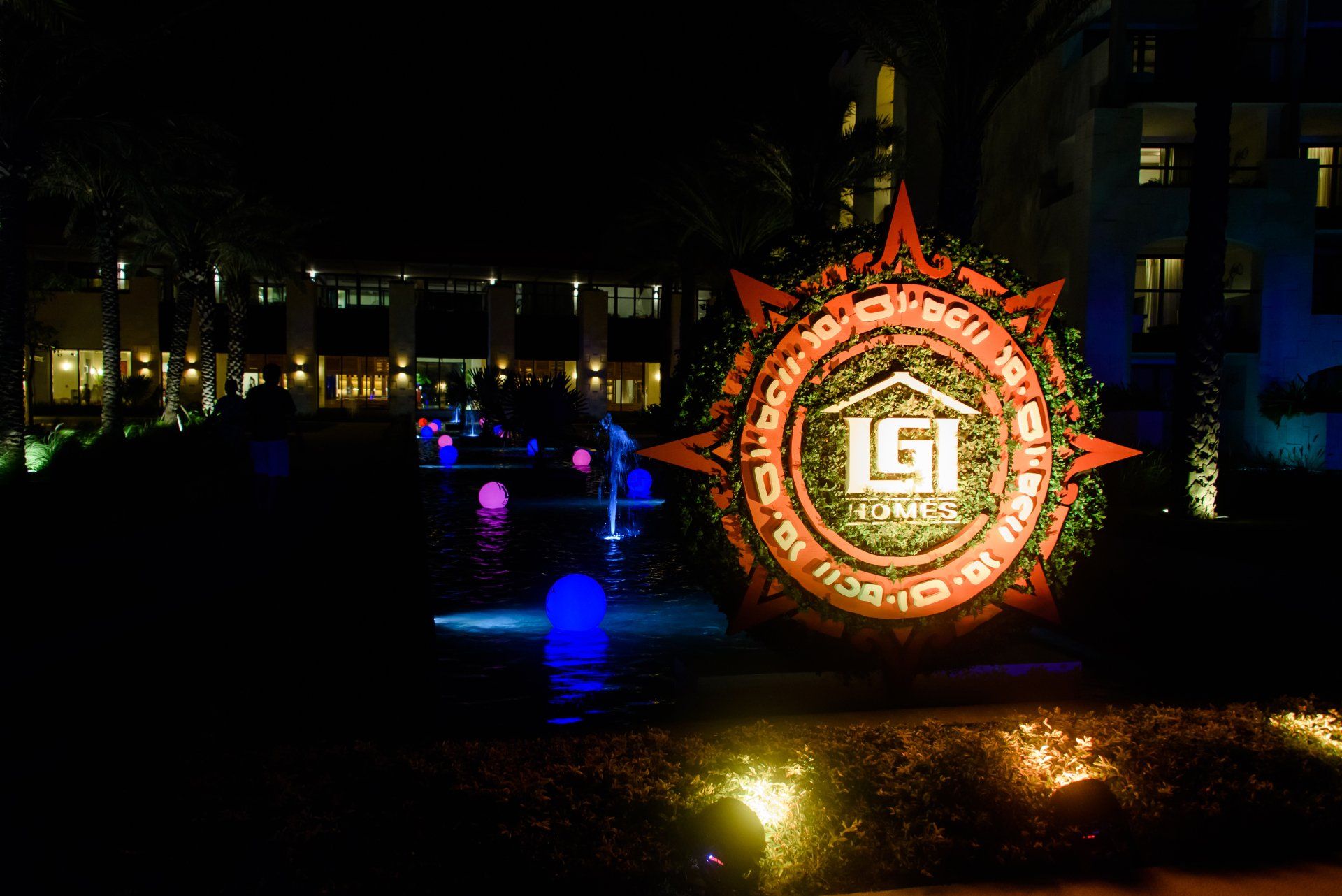 A sign that says lgi is lit up at night
