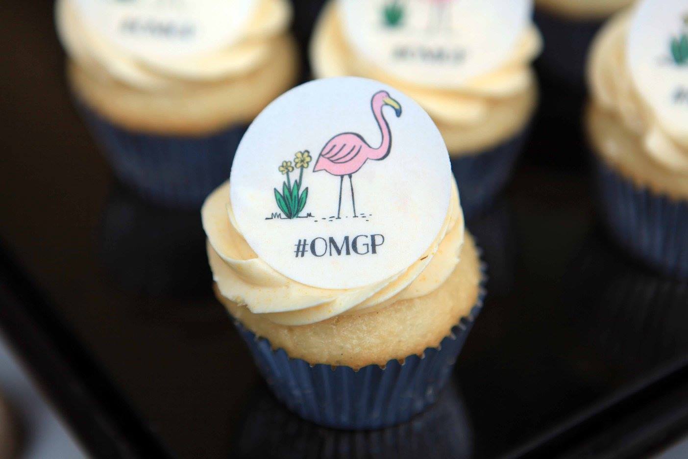 A close up of a cupcake with a flamingo on it