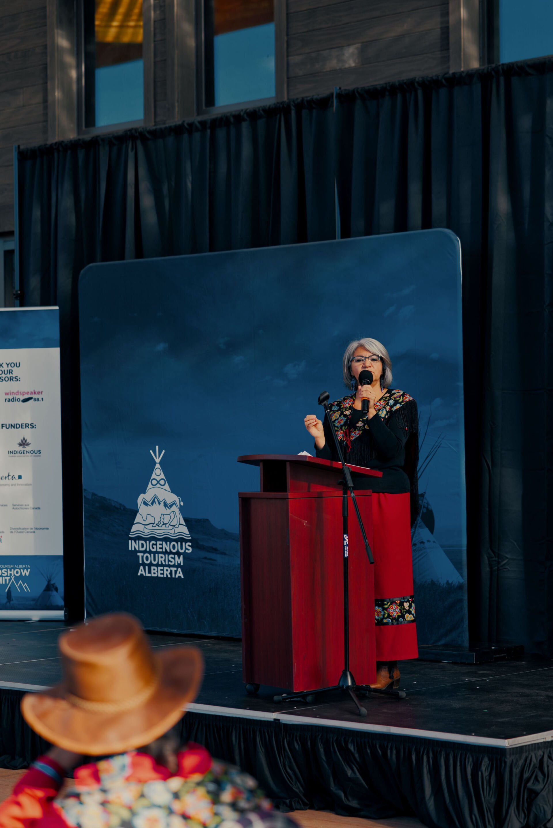 A woman is standing at a podium giving a speech.