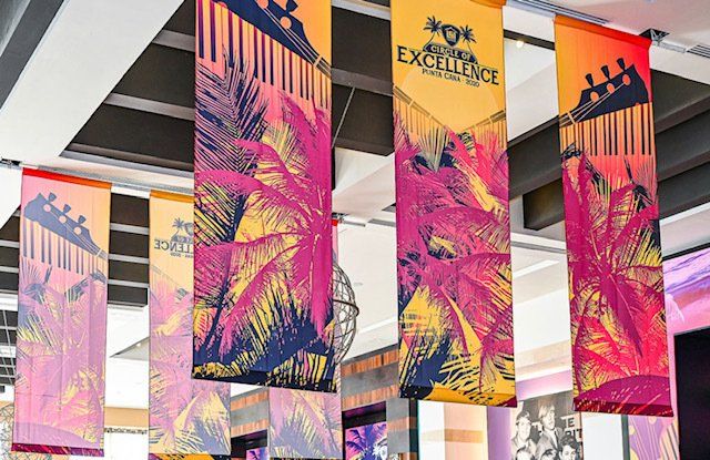 A bunch of flags are hanging from the ceiling in a room.