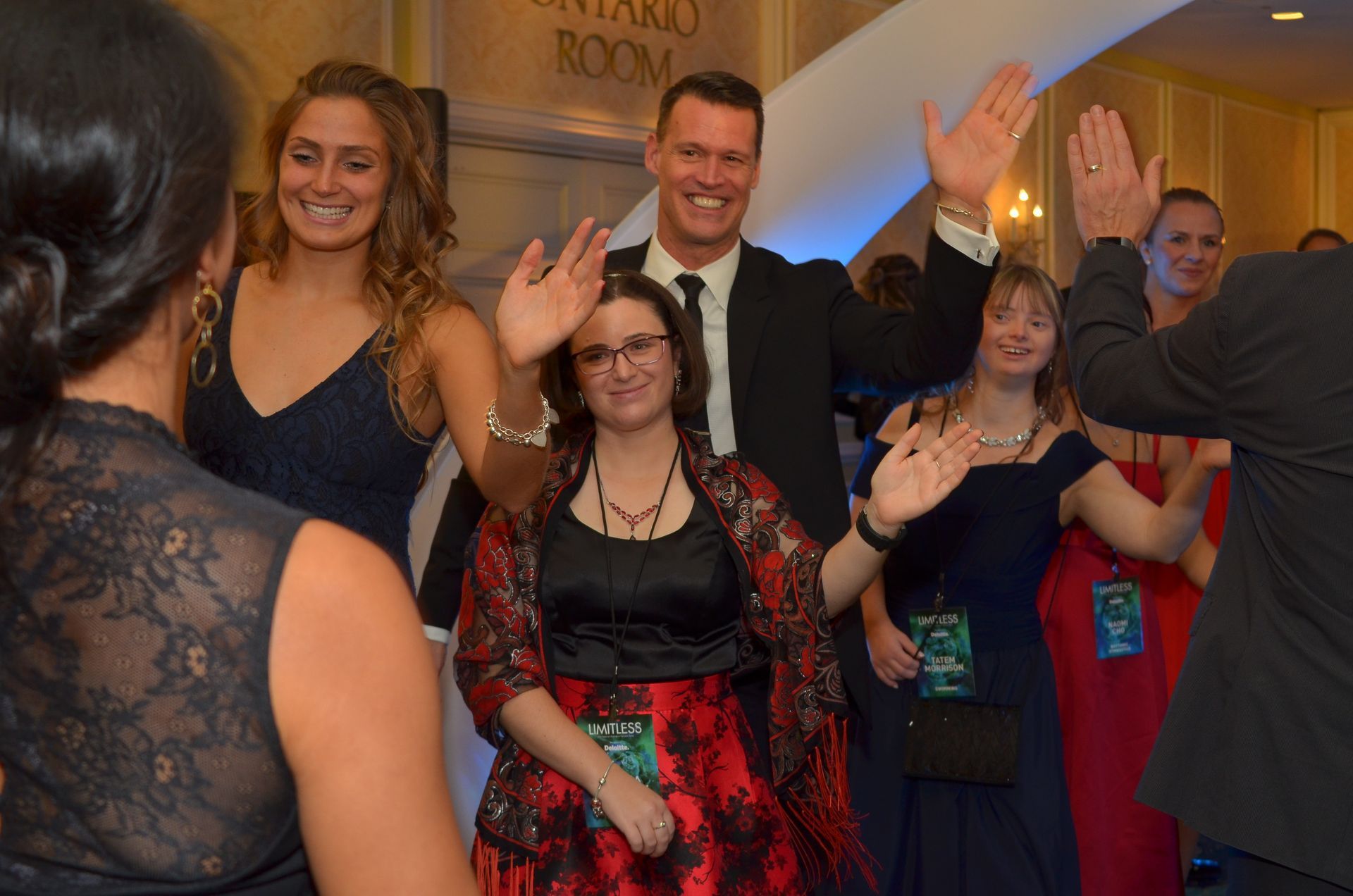 A group of people are dancing in front of a sign that says central room