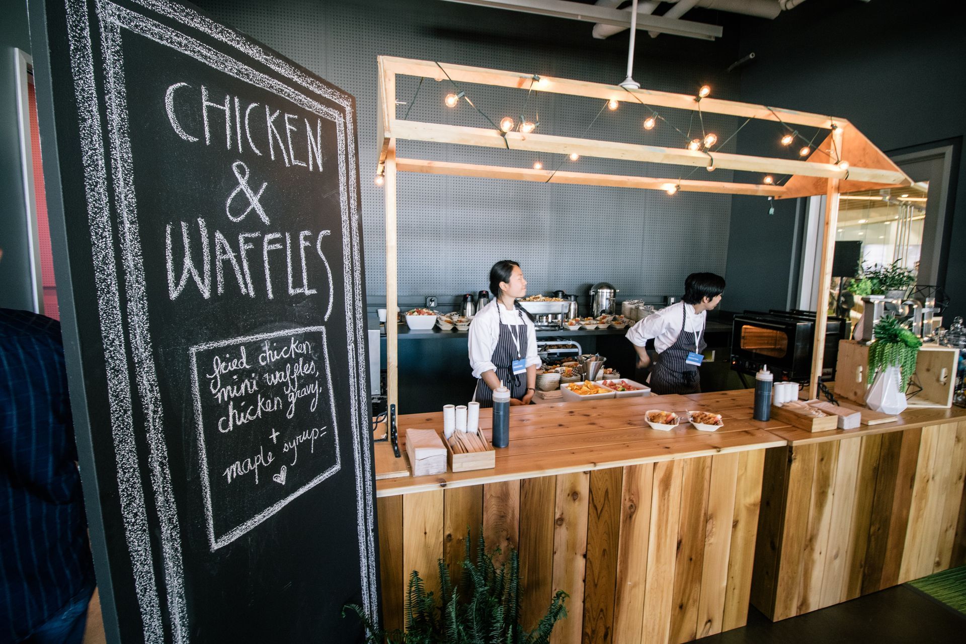A restaurant with a sign that says chicken and waffles on it.