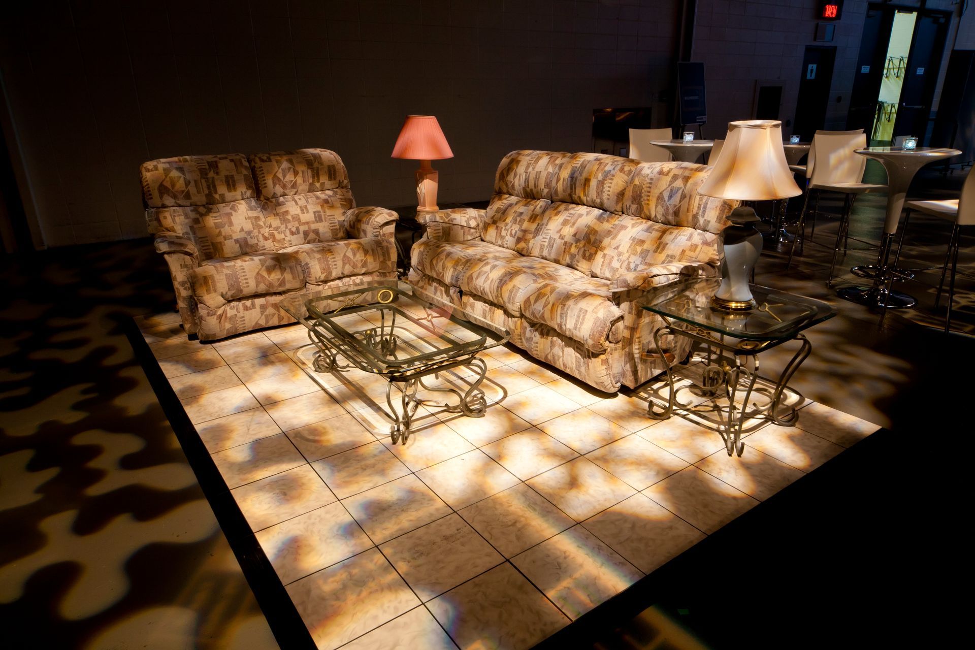 A living room with a couch a chair and two lamps