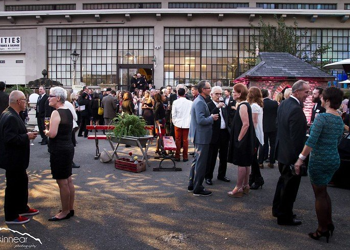 A large group of people are standing outside of a building.