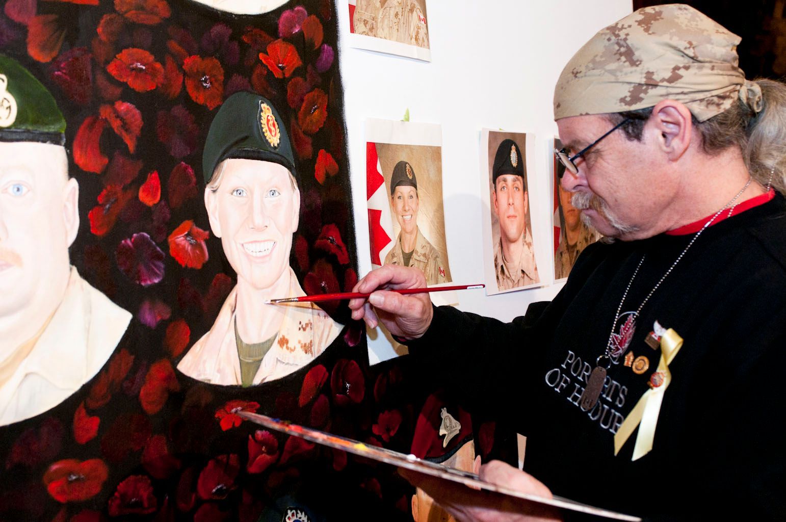 A man is painting a picture of a soldier on a canvas