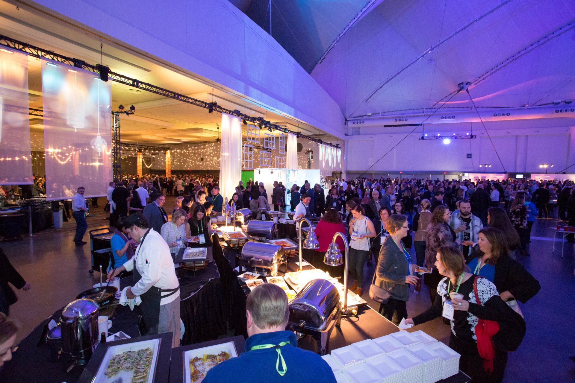 A large group of people are gathered in a large room.