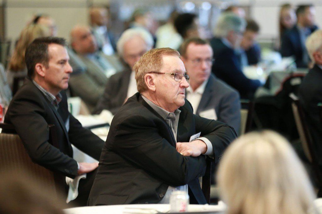 A group of people are sitting at tables in a room.