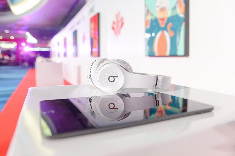 A pair of beats headphones sitting on top of a tablet