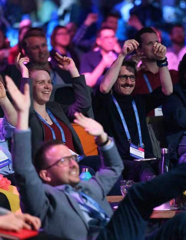 Audience members having fun at a conference
