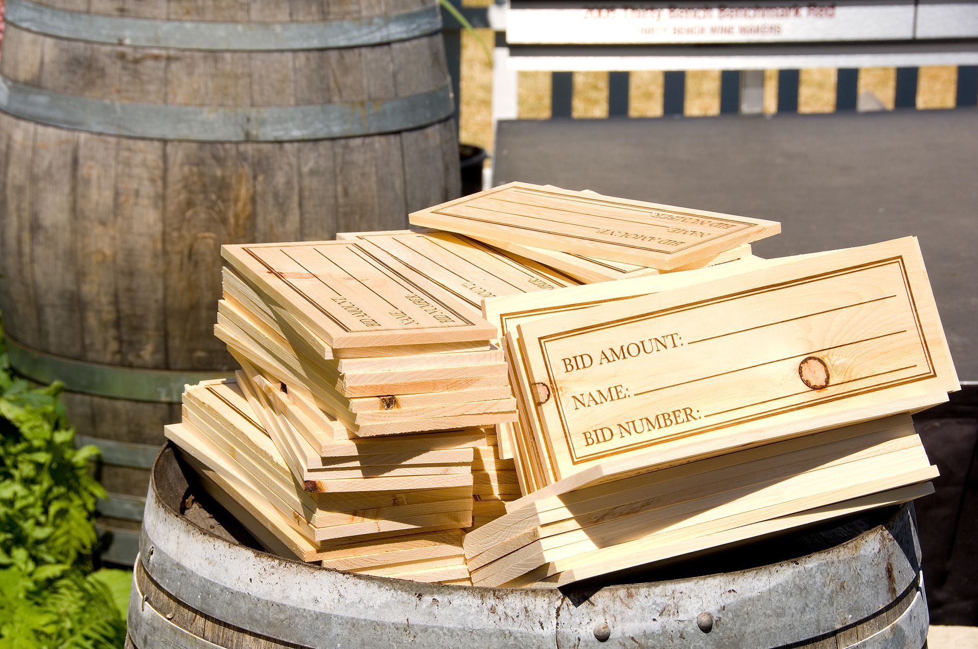 Wooden gift box lids stacked on barrel, with a barrel in the background.
