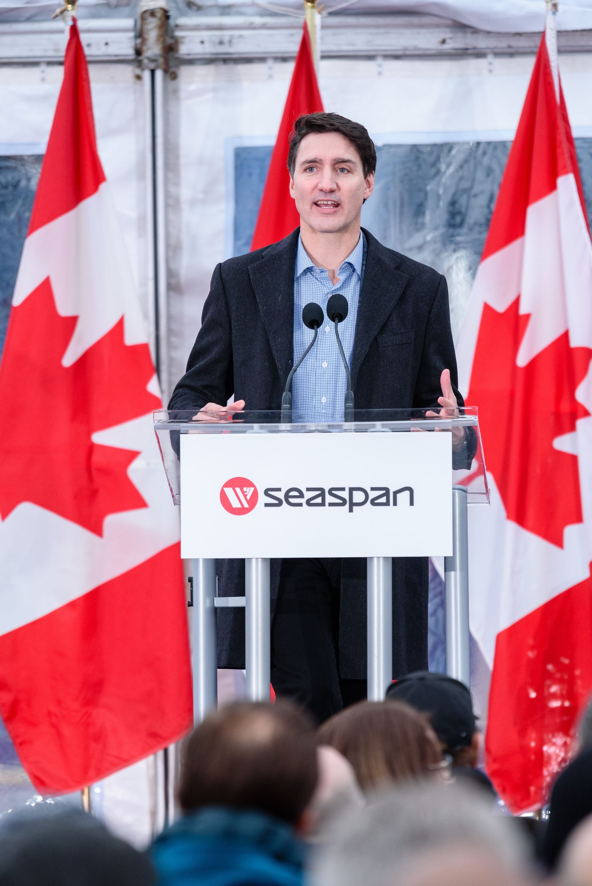 A man stands at a podium with the word seaspan on it
