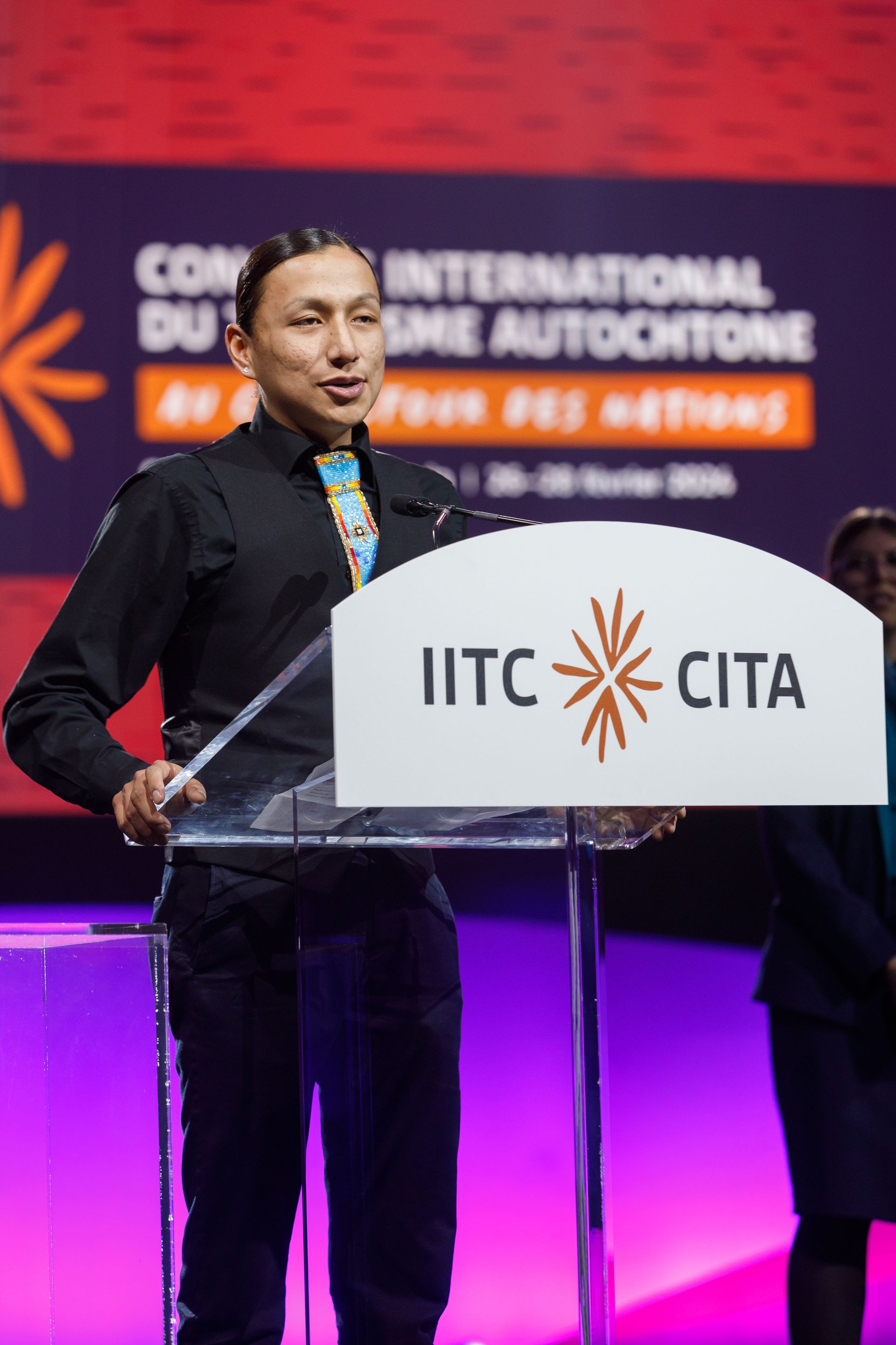 Man speaking at a podium with 