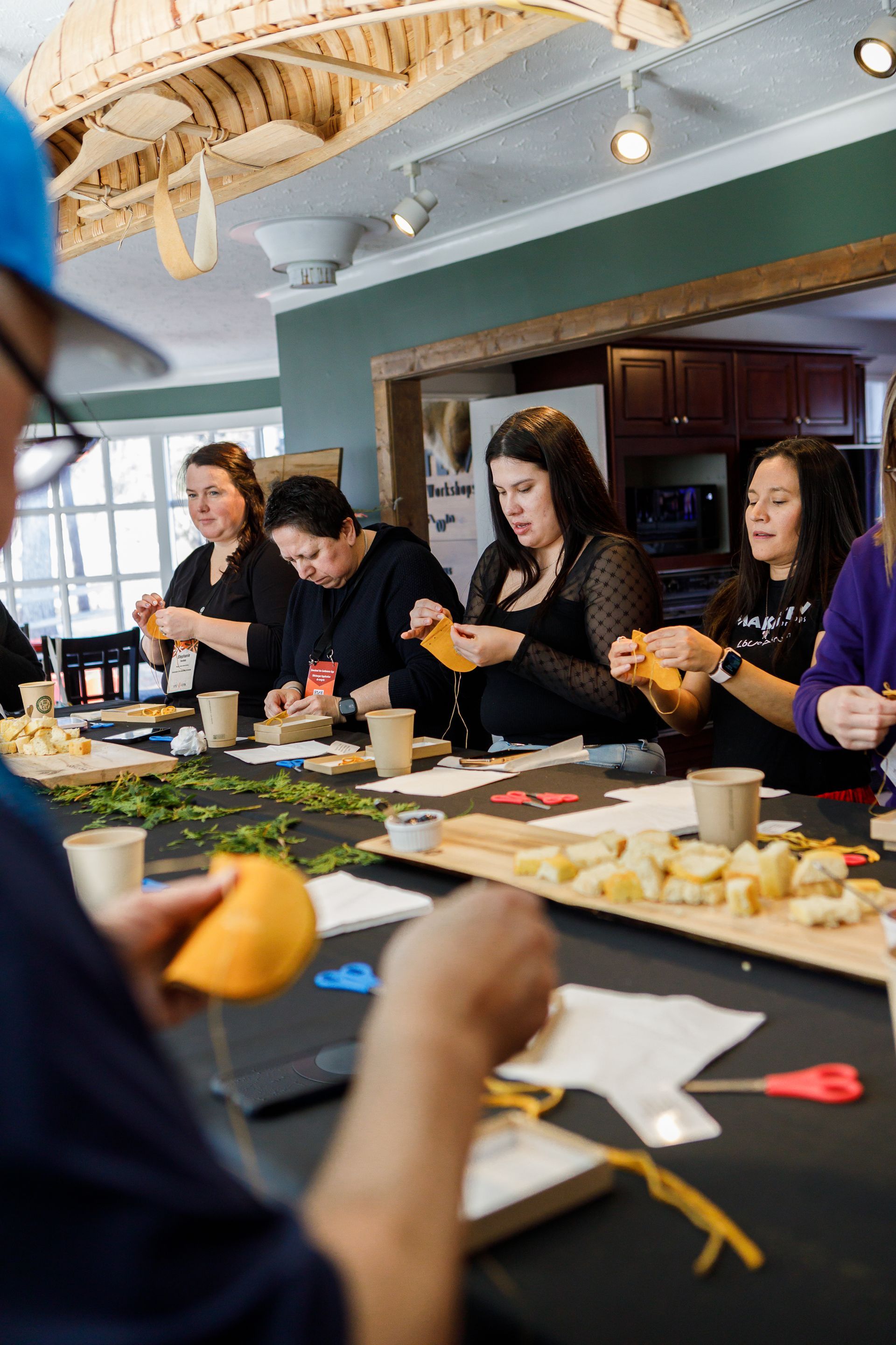 A group of people are sitting around a table making crafts.