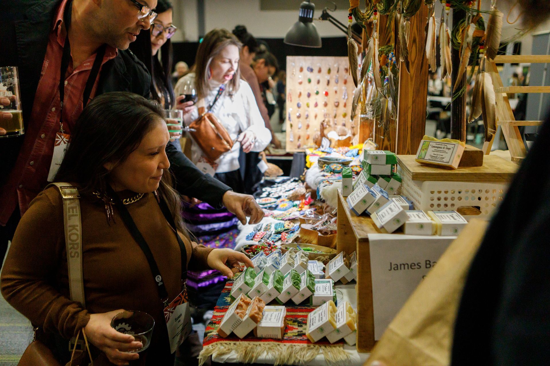 A group of people are standing around a table at a market.
