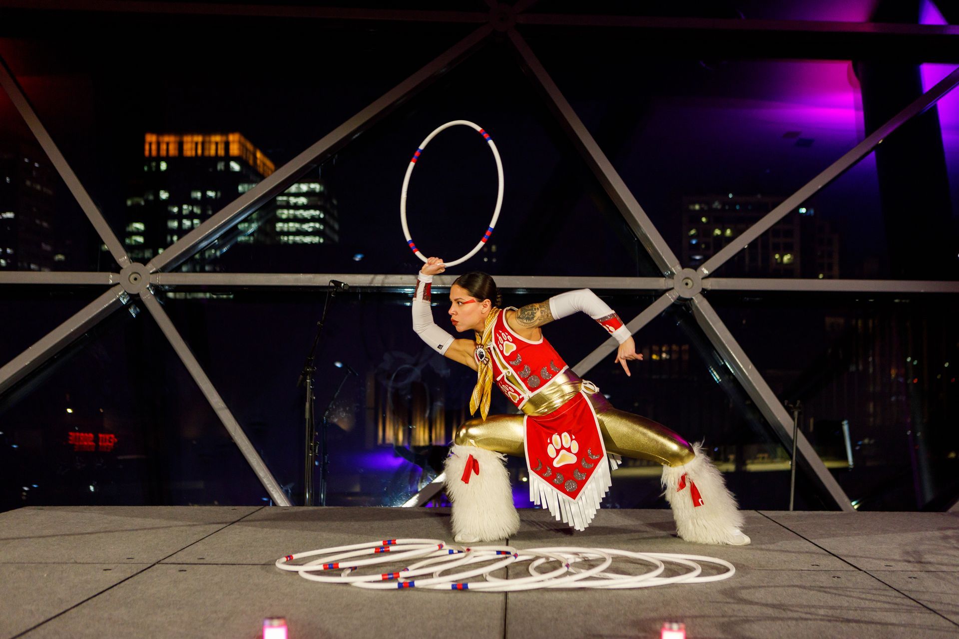 An Indigenous dancer performing a traditional hoop dance